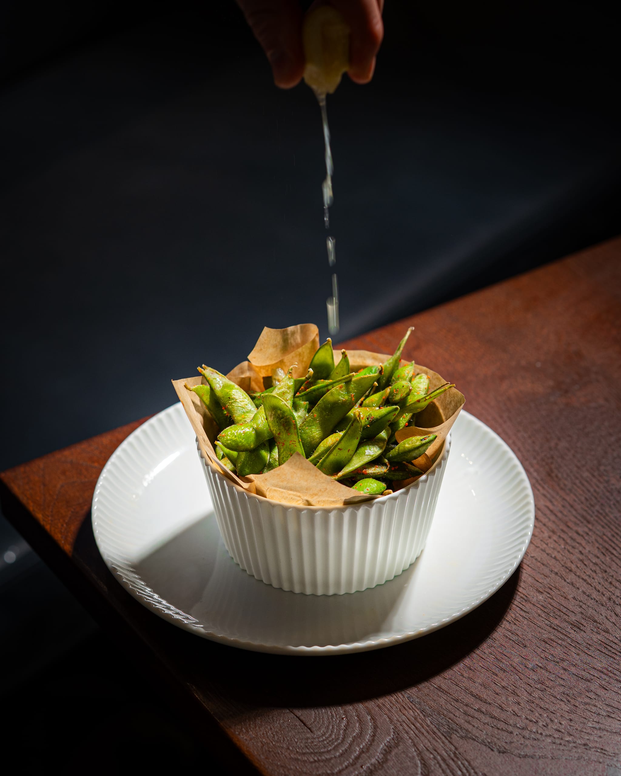 Lemon squeezed over edamame