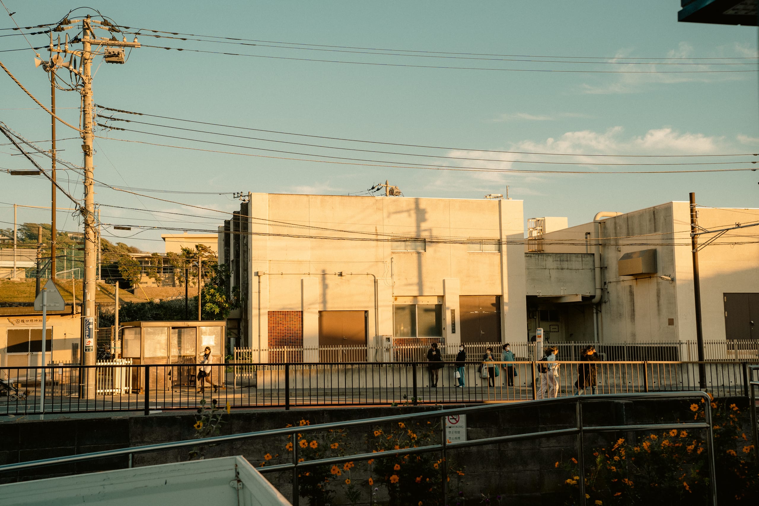 Low building at golden hour beside power lines