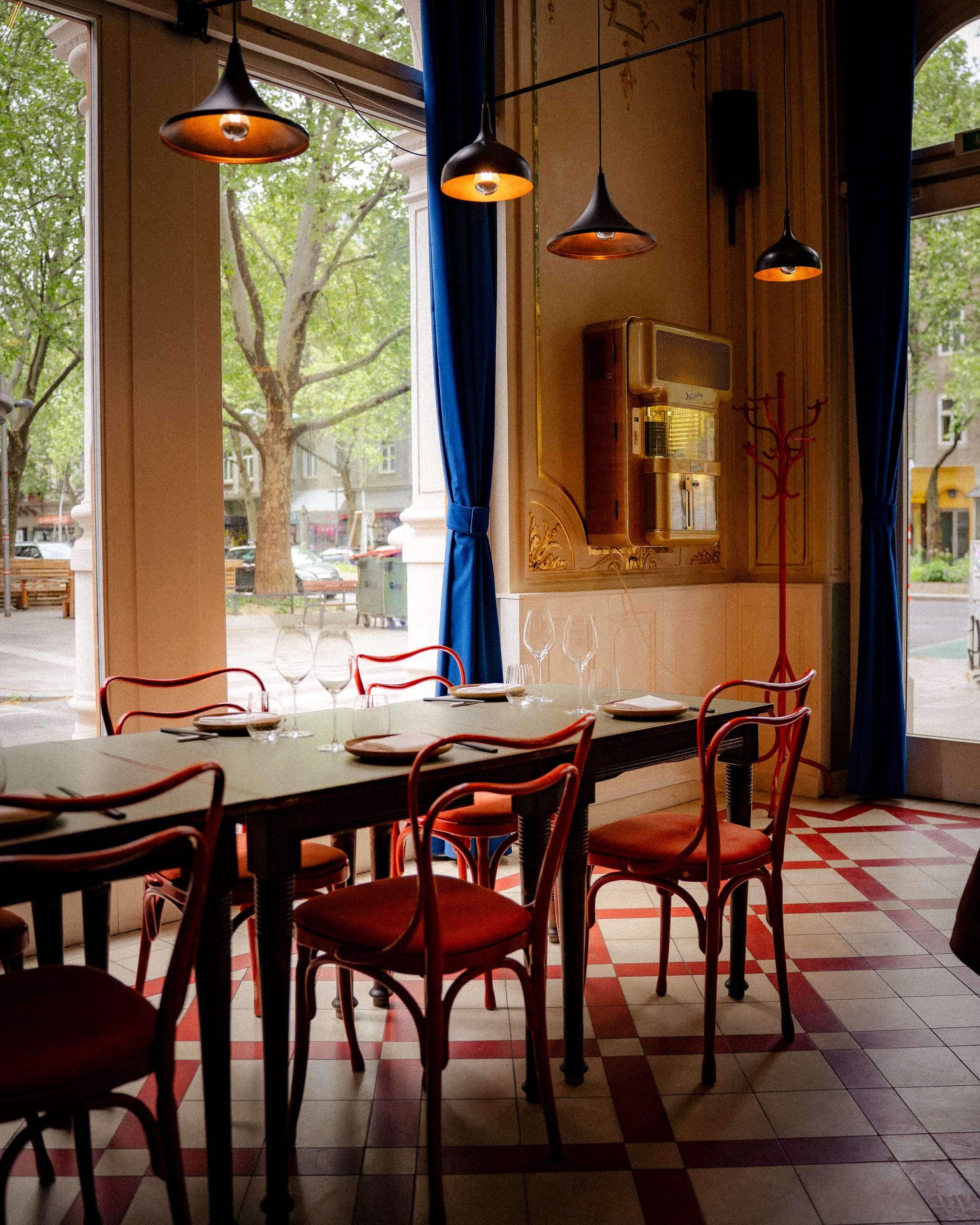 Dining room with red chairs and a tiled floor