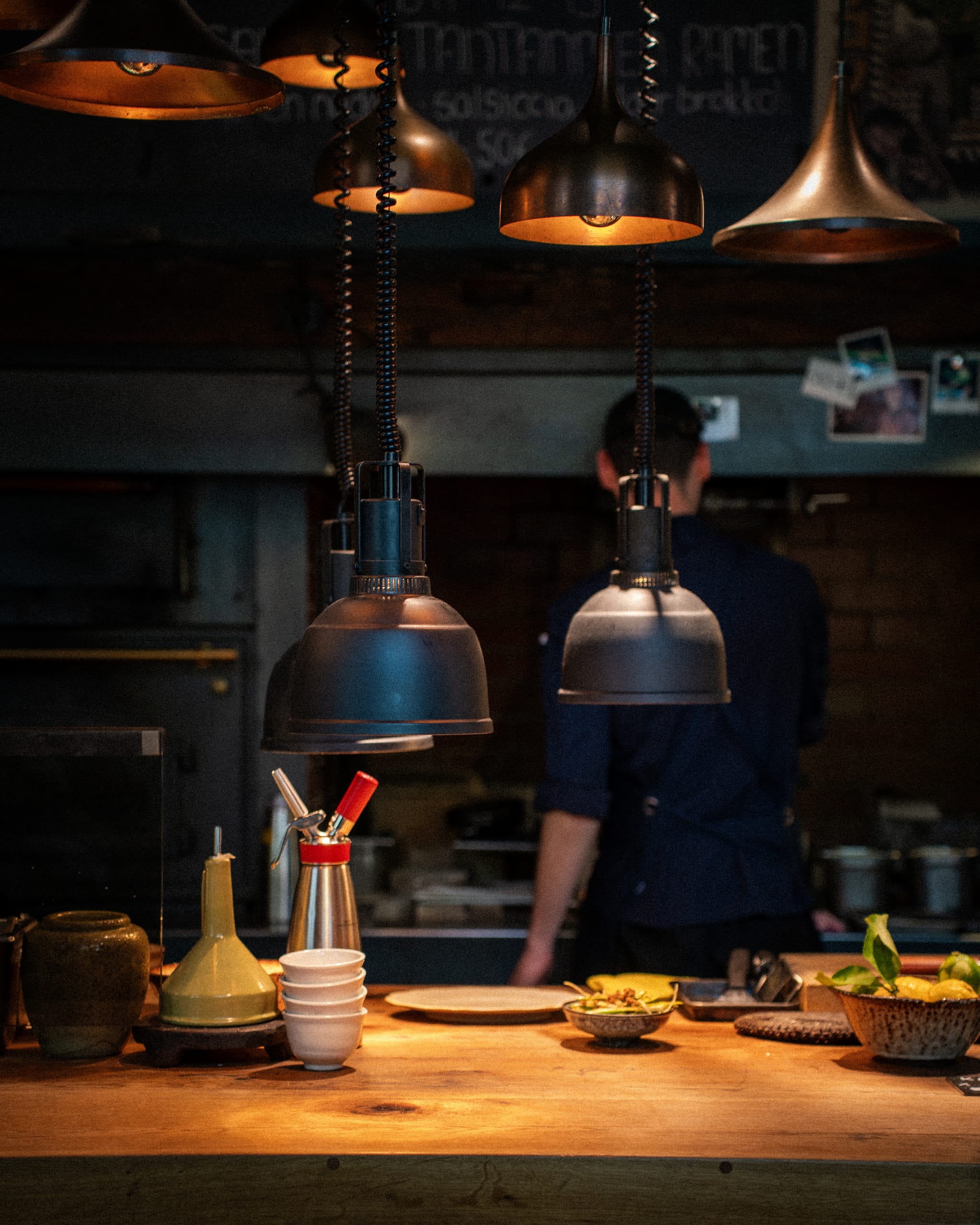 Open kitchen under brass pendant lights
