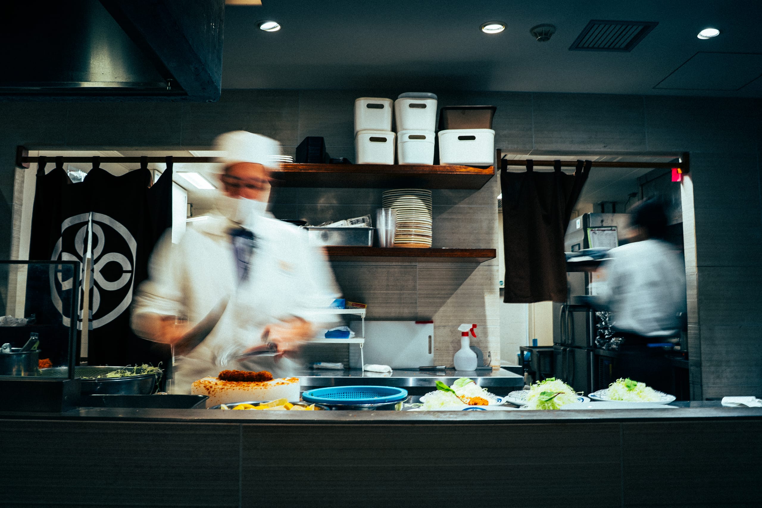 Chef at the pass of an open kitchen