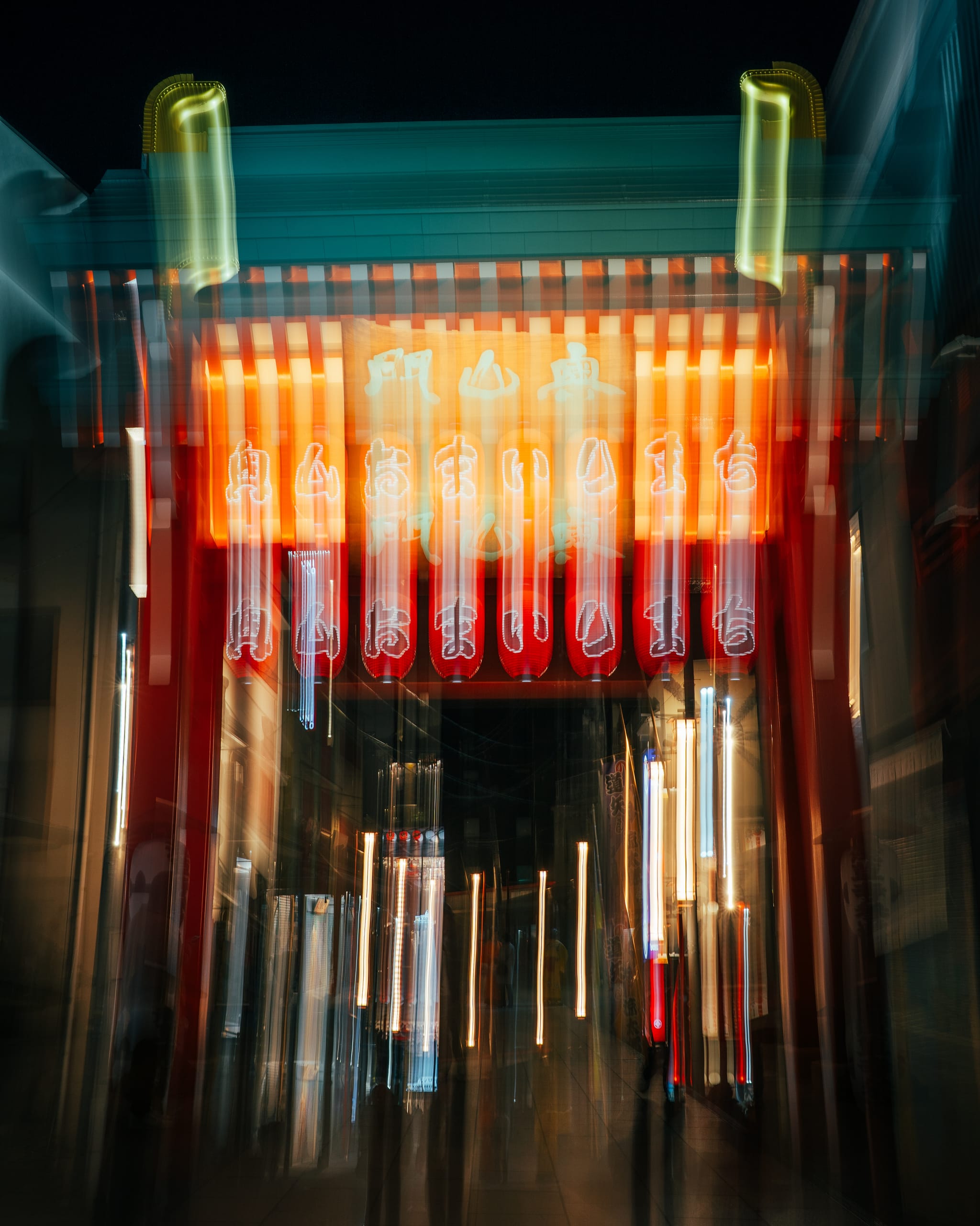 Shrine lanterns drawn into streaks by a moving camera