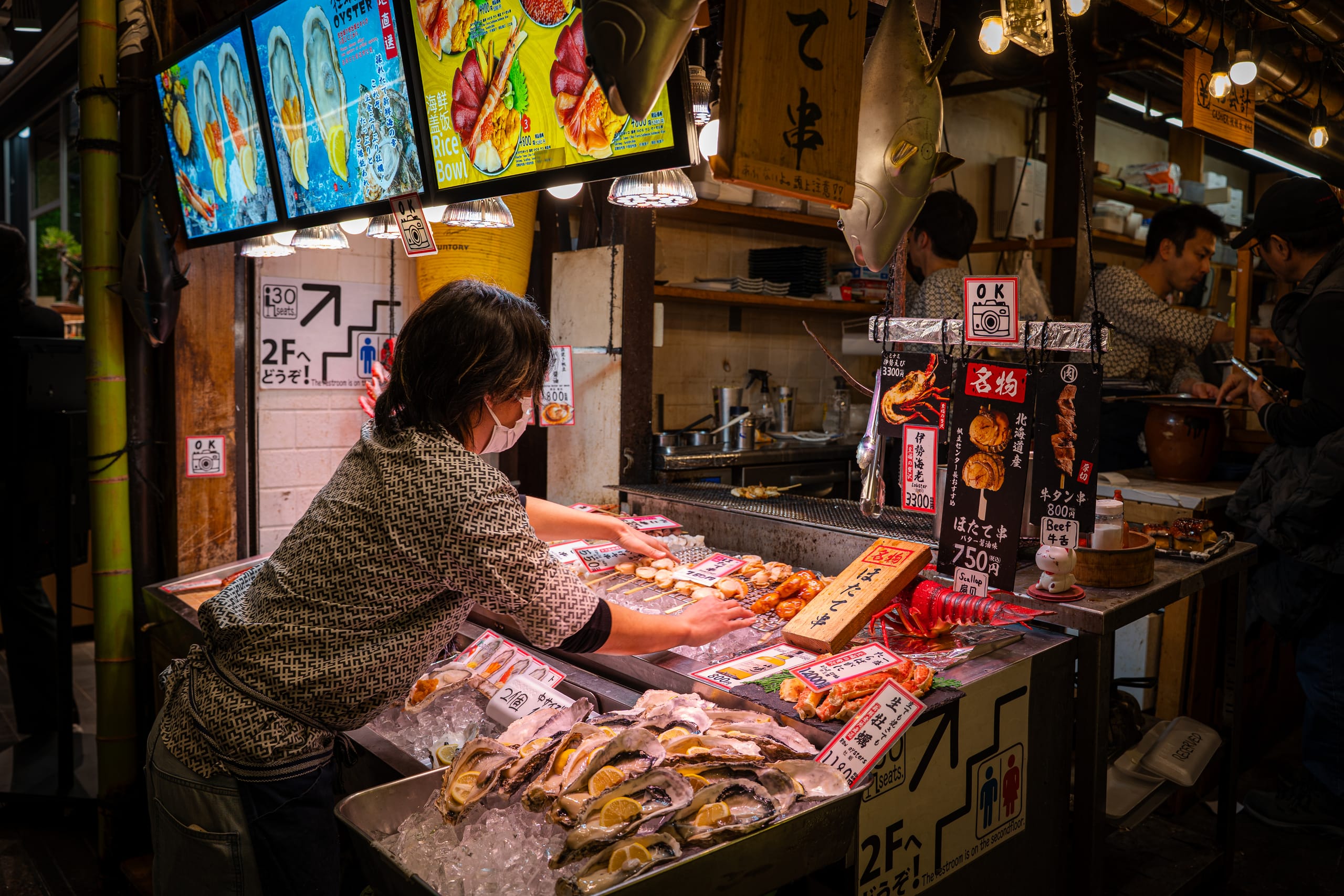 Vendor arranging seafood at a market stall