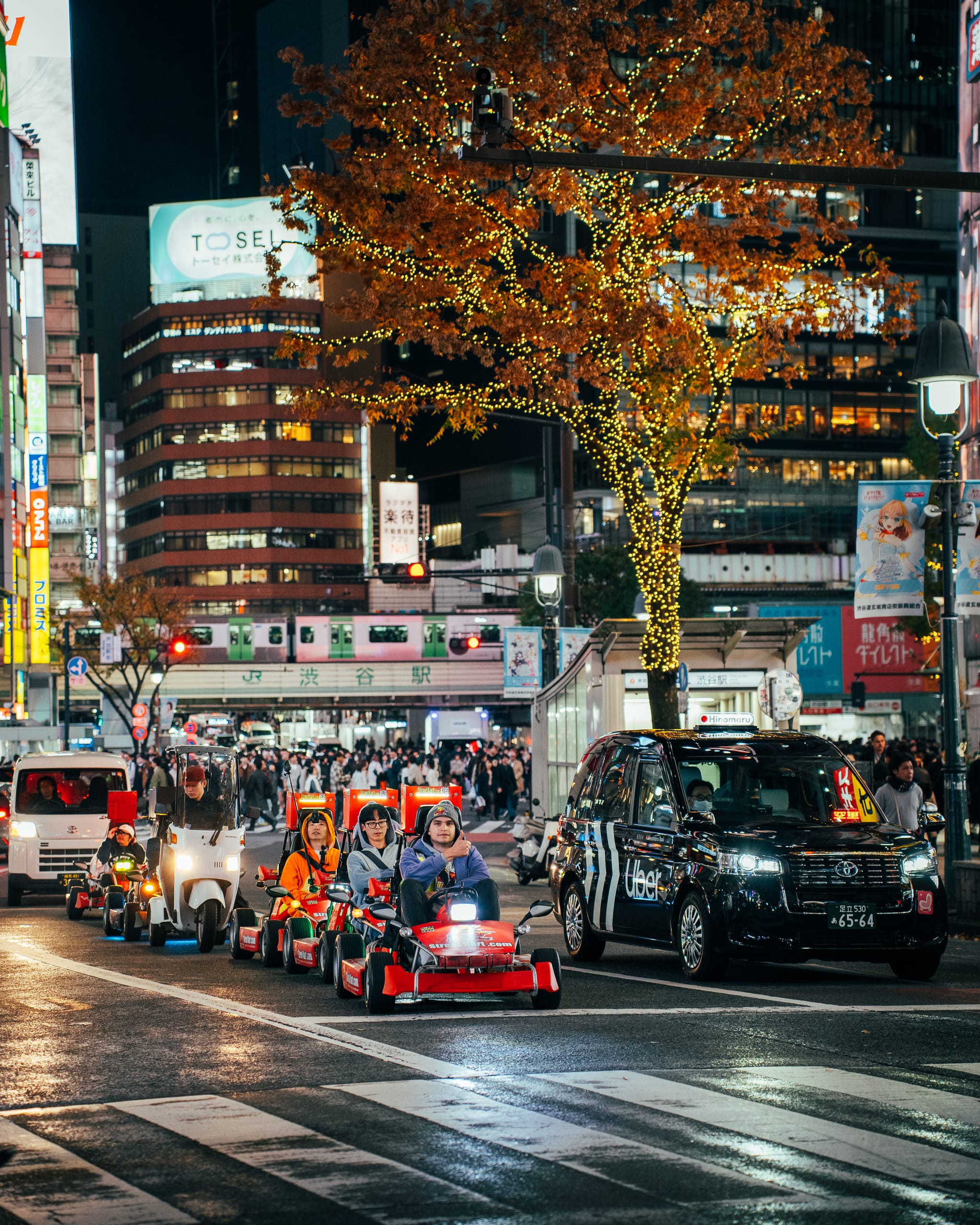 Go-karts and taxis at a neon crossing