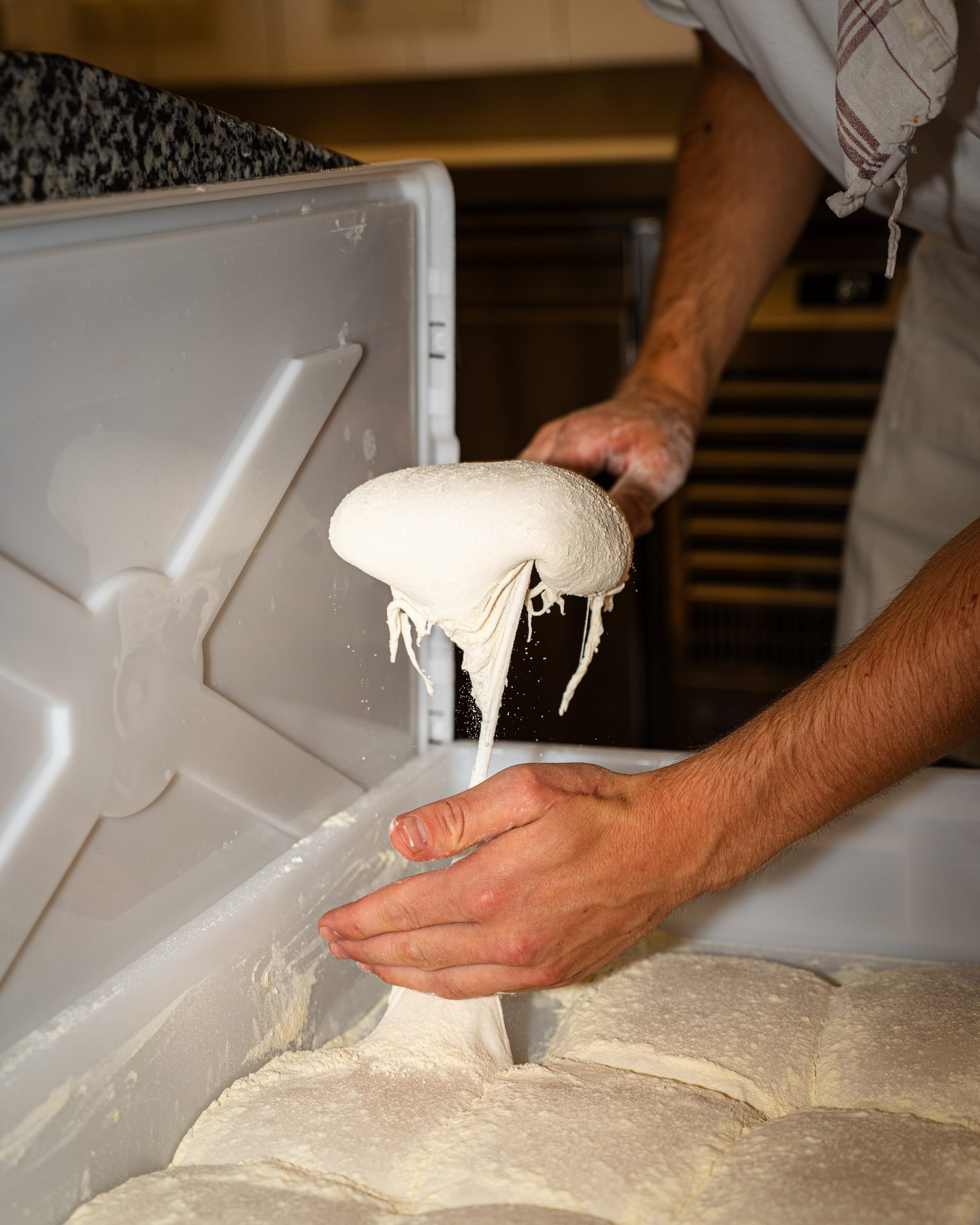 Hands stretching pizza dough