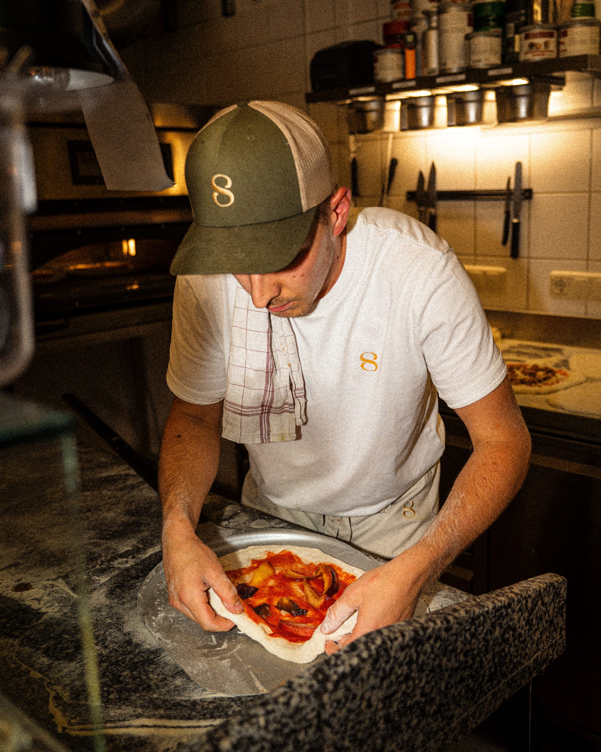Pizzaiolo shaping a pizza
