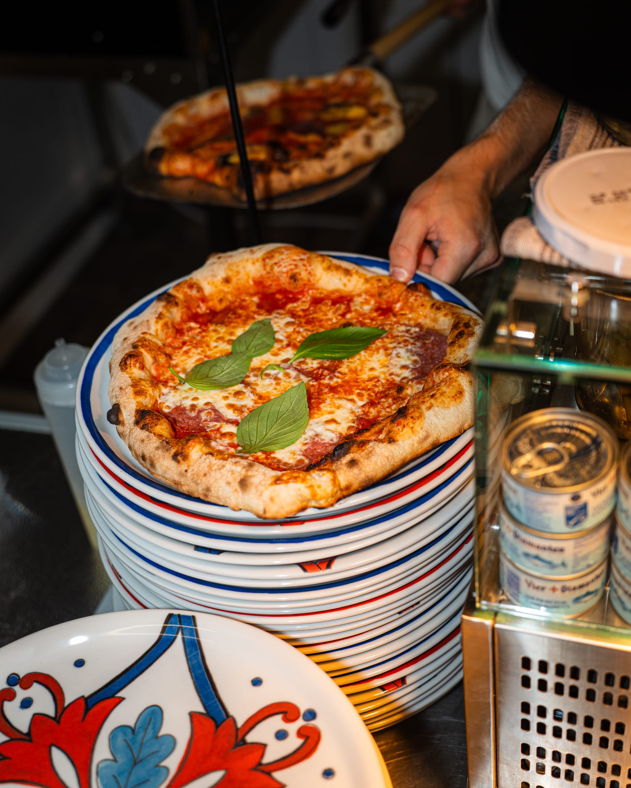 Margherita on a stack of painted plates