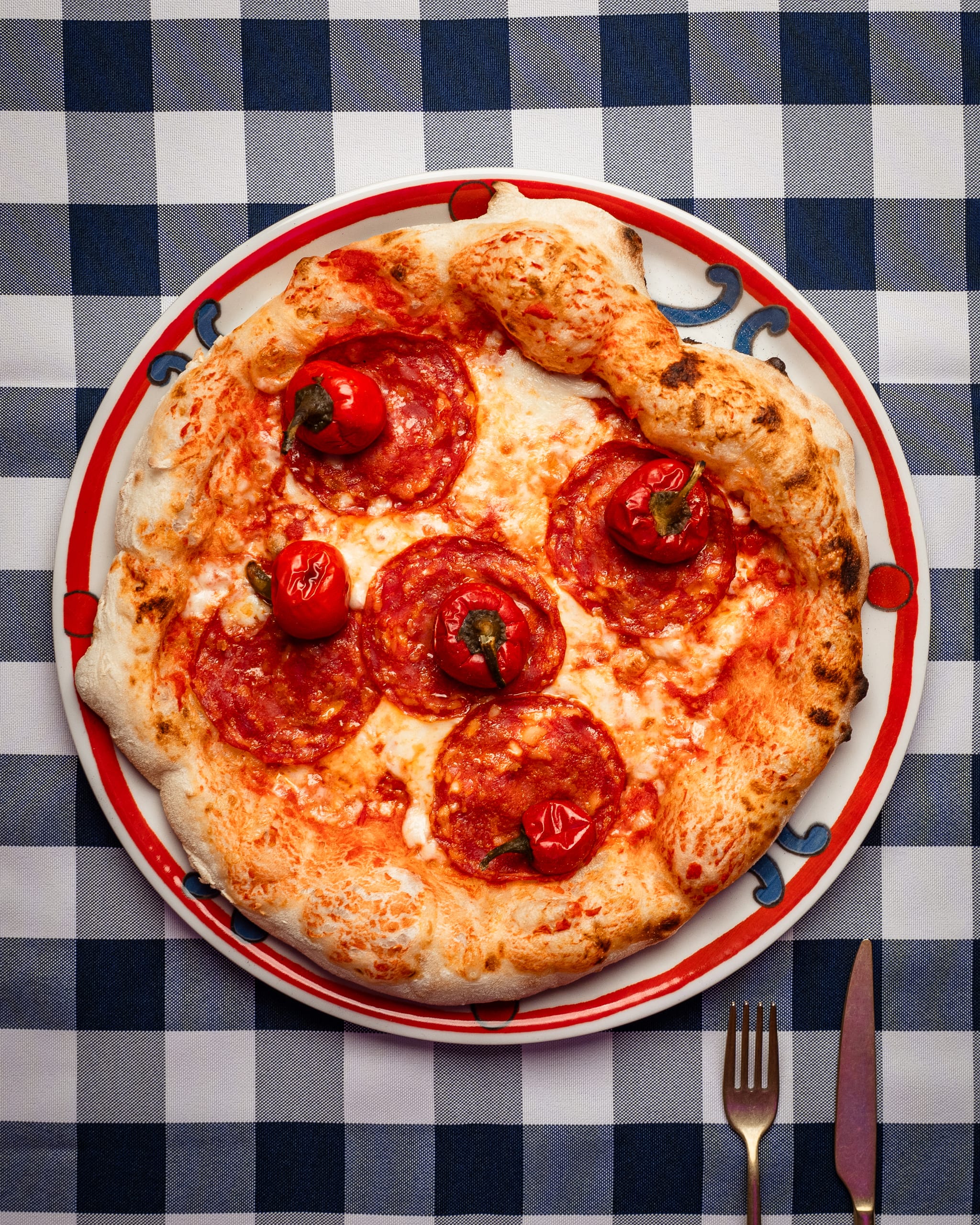 Pepperoni pizza on a gingham tablecloth